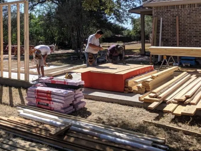 Esteban Design + Build crew framing a custom garage on a new slab in San Antonio