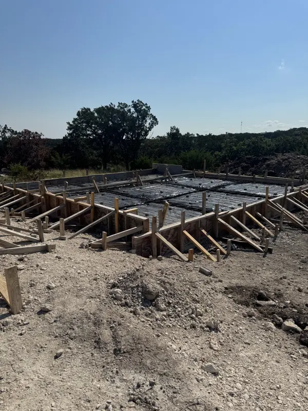 Engineered foundation forms and steel on a sloped homesite