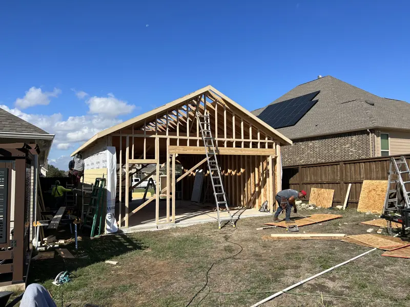 Garage addition framed beside the main home