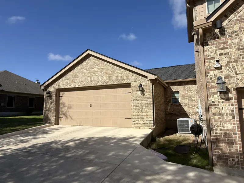 Brick two-car garage with wide driveway
