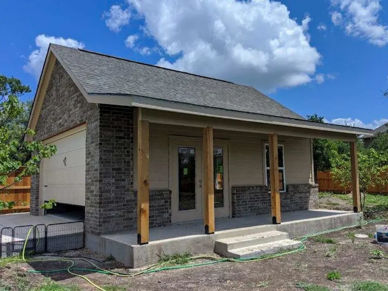 Custom garage with stone-column covered porch
