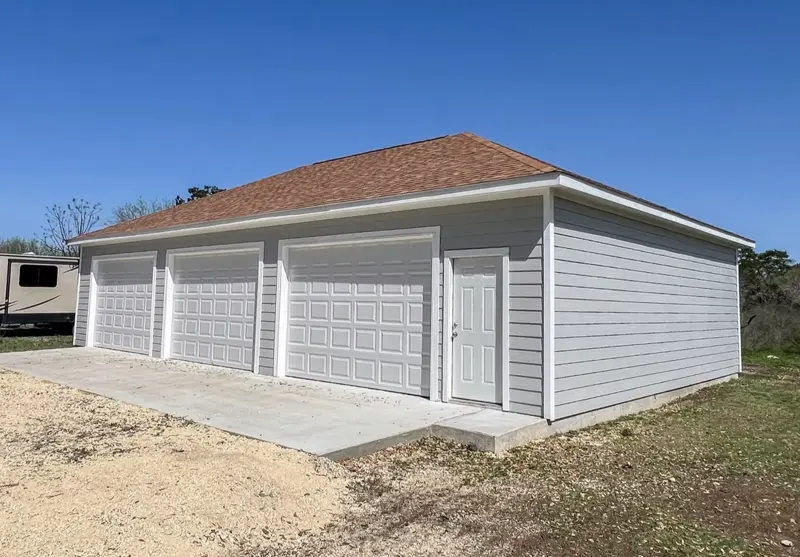 Gray two-bay garage with side entry door