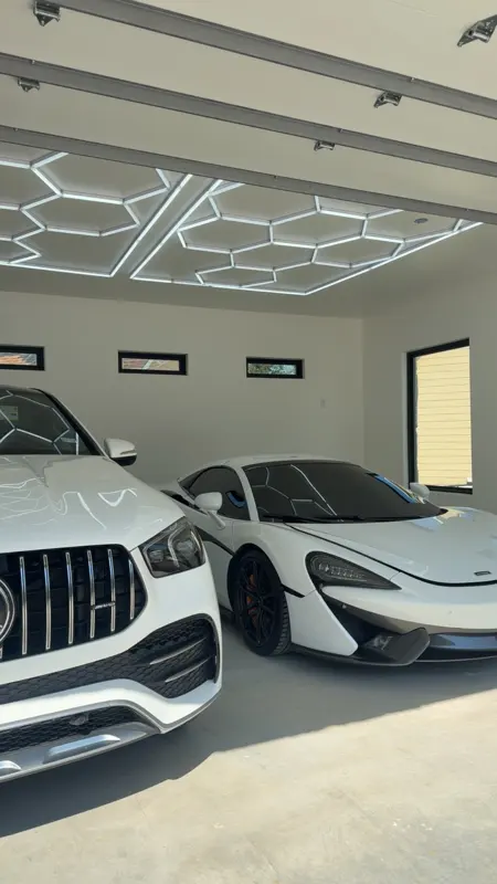 Finished garage interior with custom LED ceiling and supercars