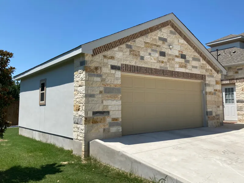 Detached garage with stone and brick accent gable