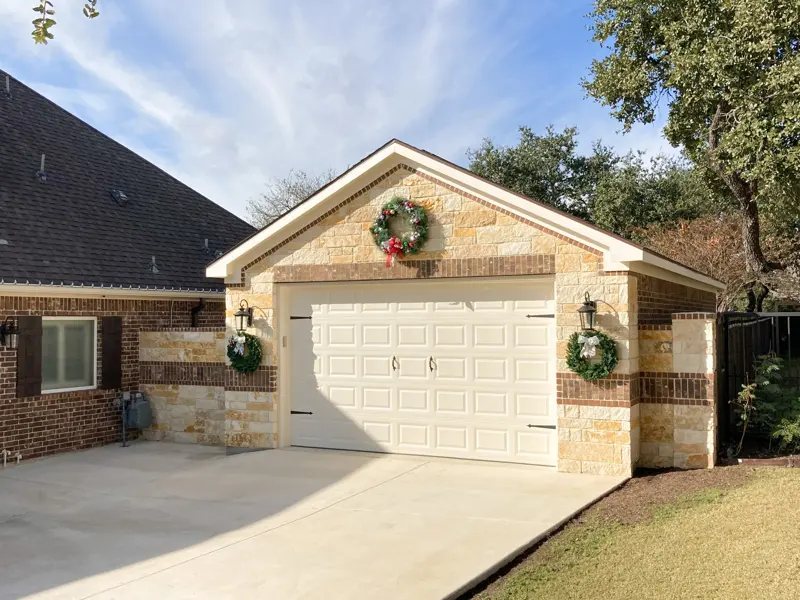 Detached garage with Austin stone and brick built to match the home