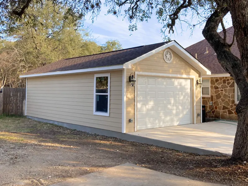 Detached garage with Texas star medallion above the door