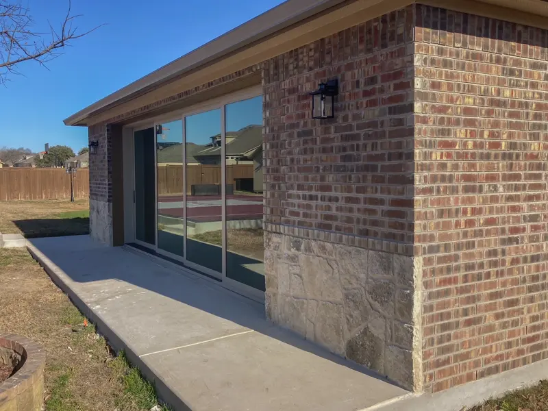 Home gym garage exterior with floor-to-ceiling glass