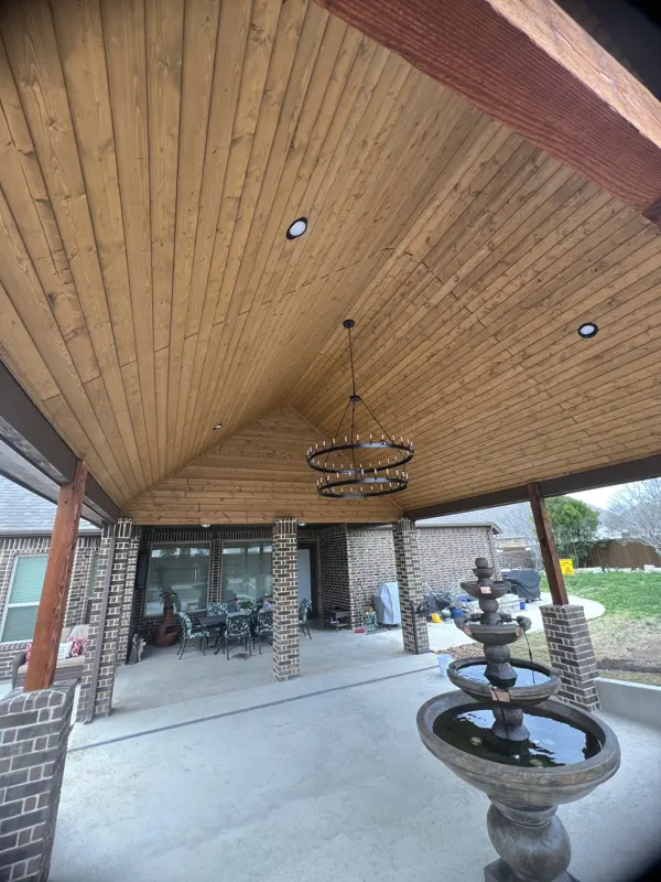 Wood-ceiling patio cover with chandelier and courtyard fountain