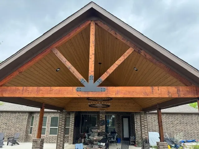 Gabled patio cover with stained wood ceiling and chandelier
