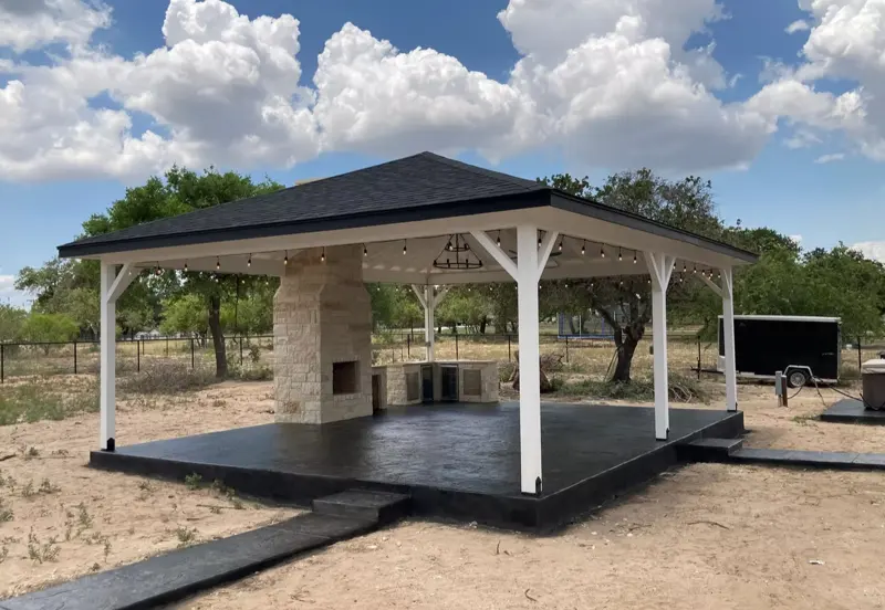 Pavilion with stone fireplace on a stained concrete slab