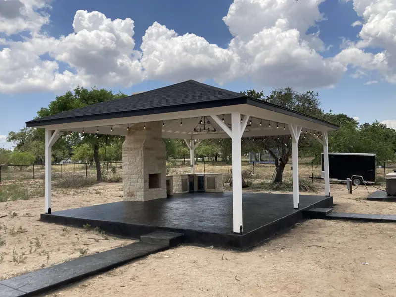 White pavilion with hip roof and string lights