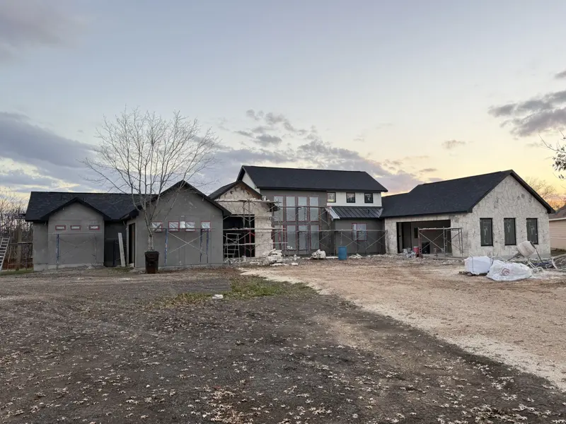 Multiple custom buildings under construction at dusk