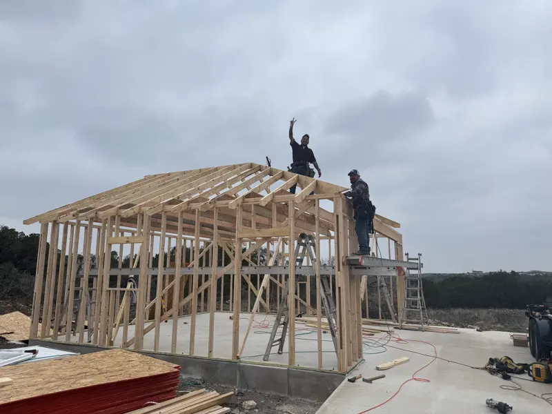 Framers setting the roof structure on a custom garage