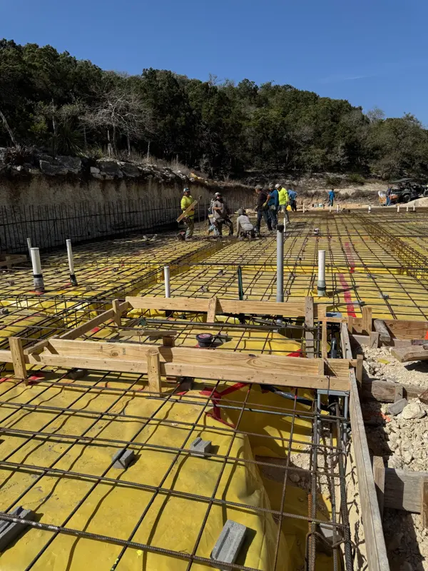 Rebar and plumbing rough-in before a garage slab pour